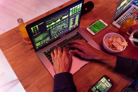 Person Using Laptop on Brown Wooden Table