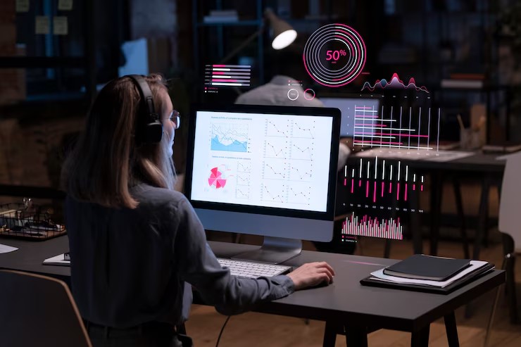 A woman monitoring real-time network traffic and user interface data on a screen, highlighting live network activity and alerts